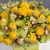 Композиция в коробке из лаймовых орхидей, гиперикума, лимонных кустовых пионовидных роз и краспедии в Дмитрове